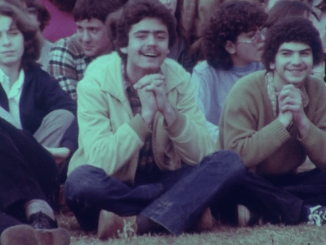 AUB students attending a concert in AUB's Green Field, 1980. From Maroun Baghdadi's 'Whispers'